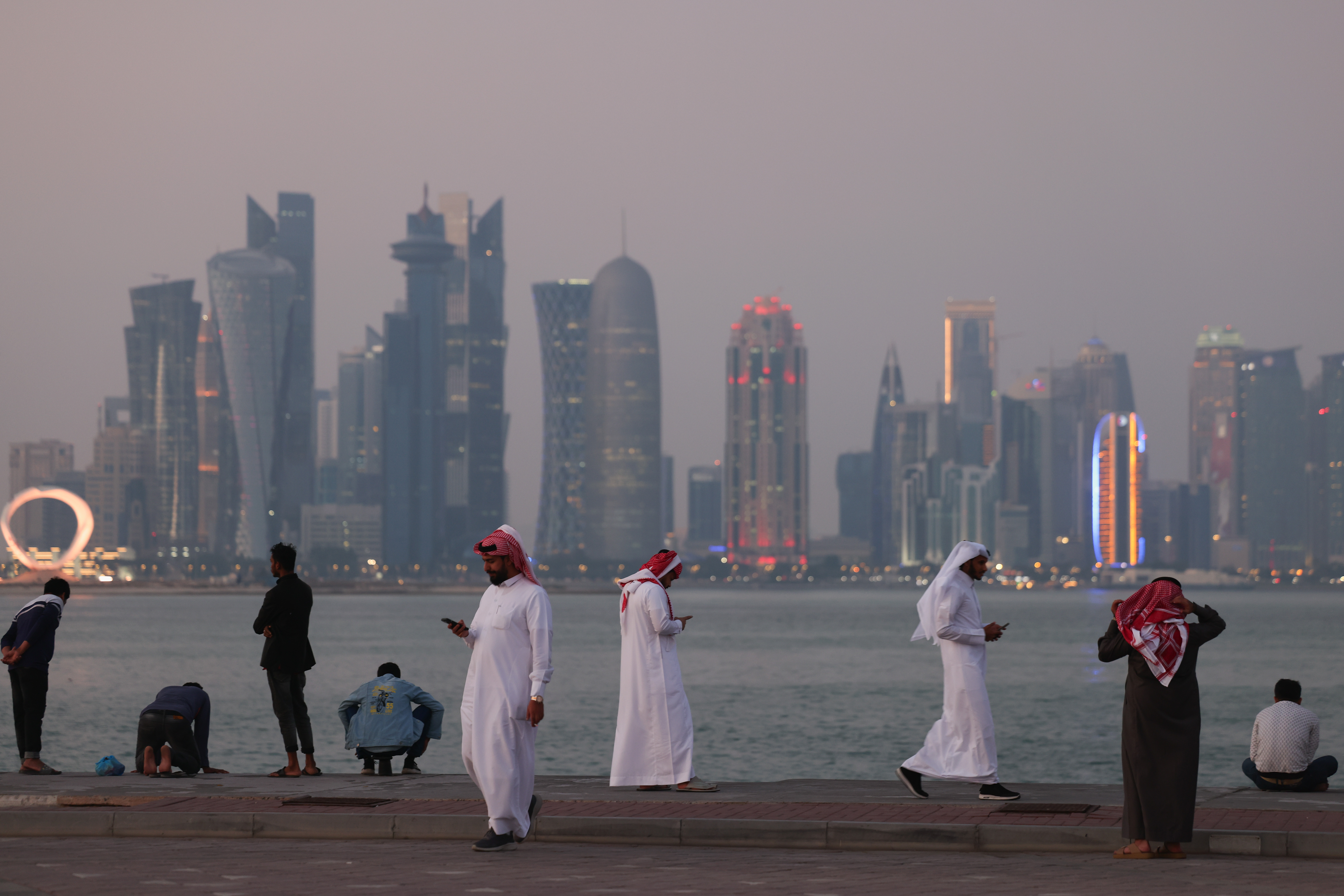 People gather at the Corniche promenade in Doha, which will host Web Summit Qatar this week. (Photo: Getty Images)