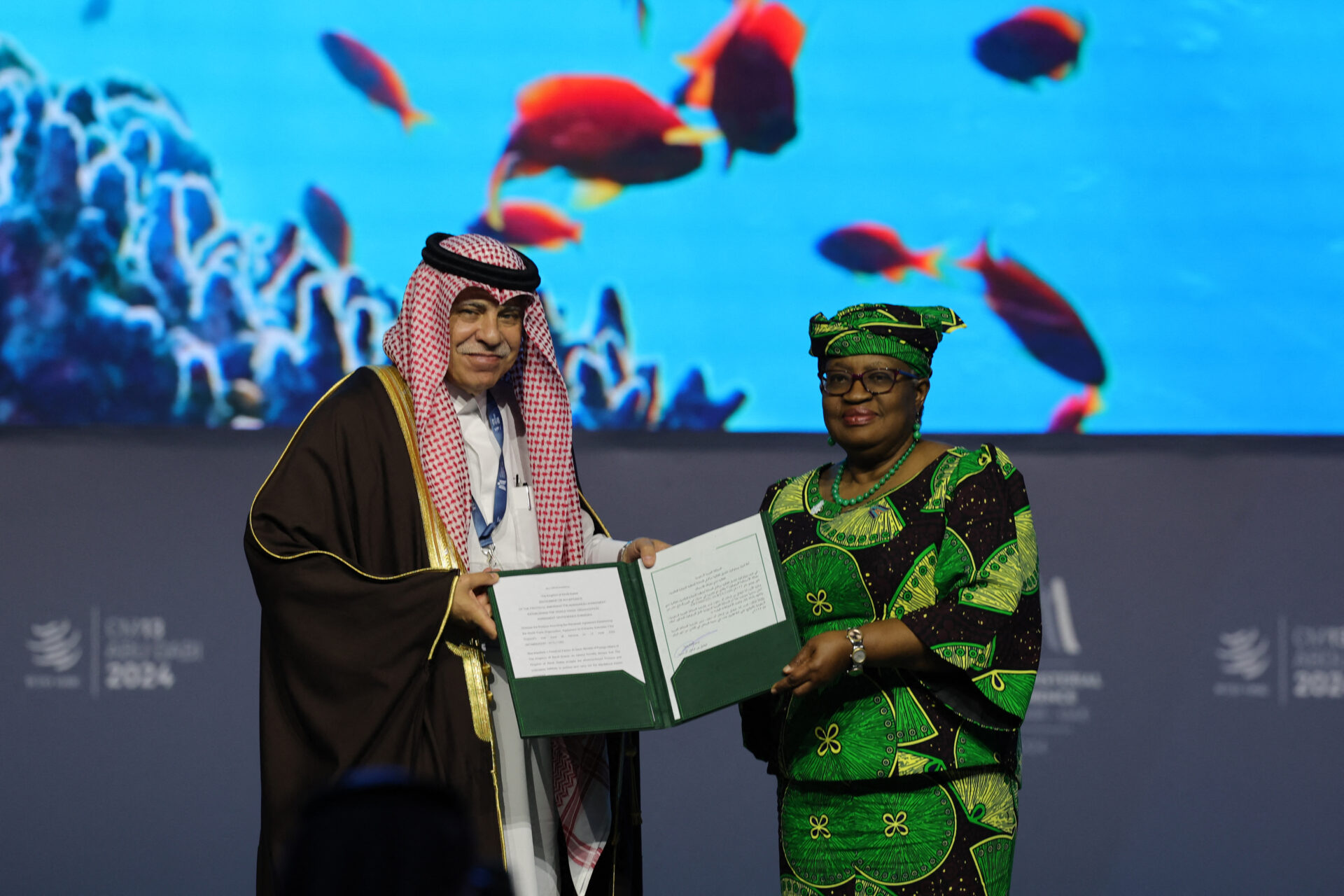 Director-General of the World Trade Organization Ngozi Okonjo-Iweala and Saudi Minister of Commerce and Investment Majid bin Abdullah Al Qasabi pose for a picture with signed documents during a session on fisheries subsidies during the 13th WTO Ministerial Conference in Abu Dhabi today. (Photo: Getty Images)