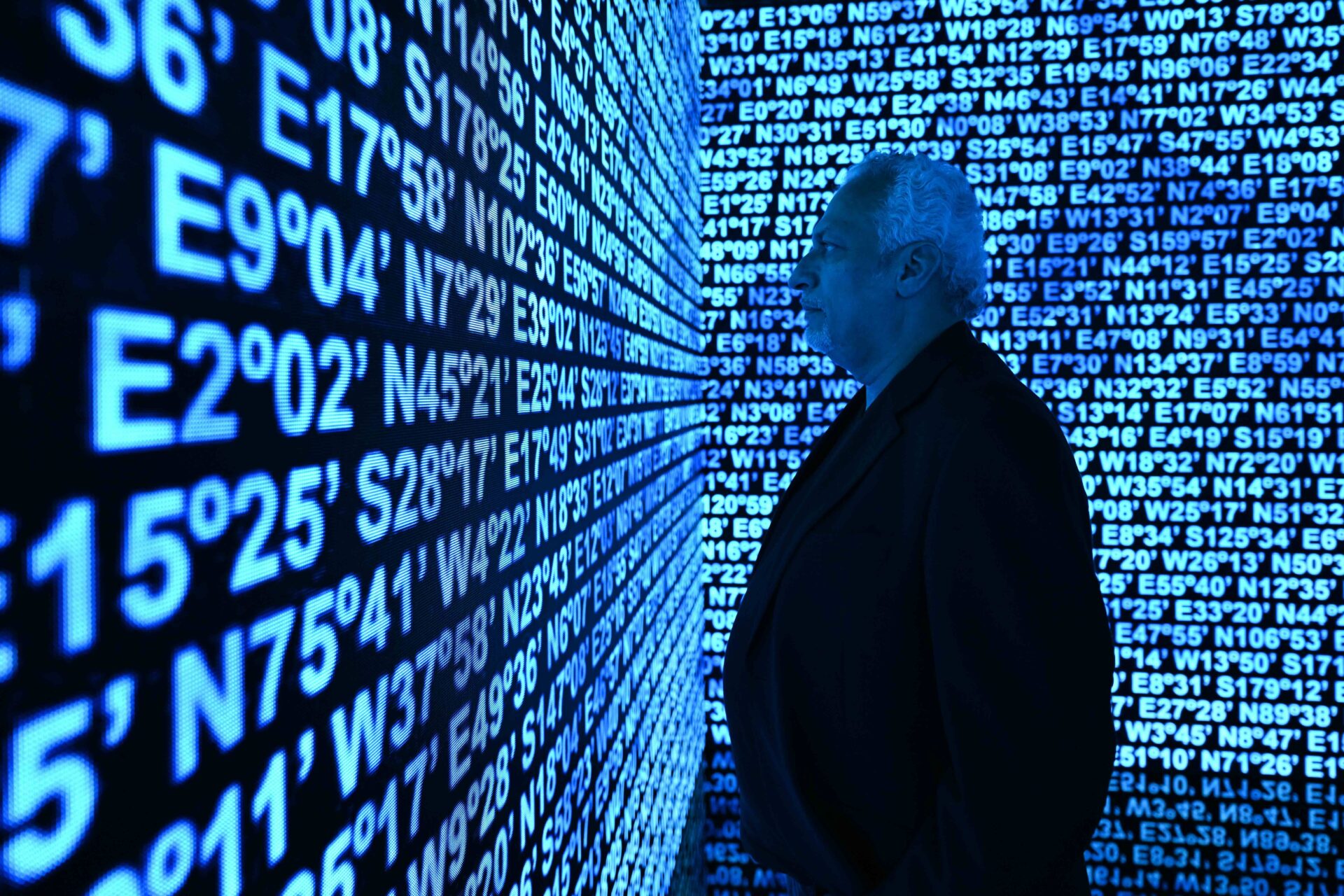 Emirati artist Mohammed Kazem with his work “Directions (Merging),” a new digital artwork commissioned by Julius Baer, which is on display at Madinat Jumeirah Conference and Events Centre for Art Dubai 2025. (Cedric Ribeiro/Getty Images)