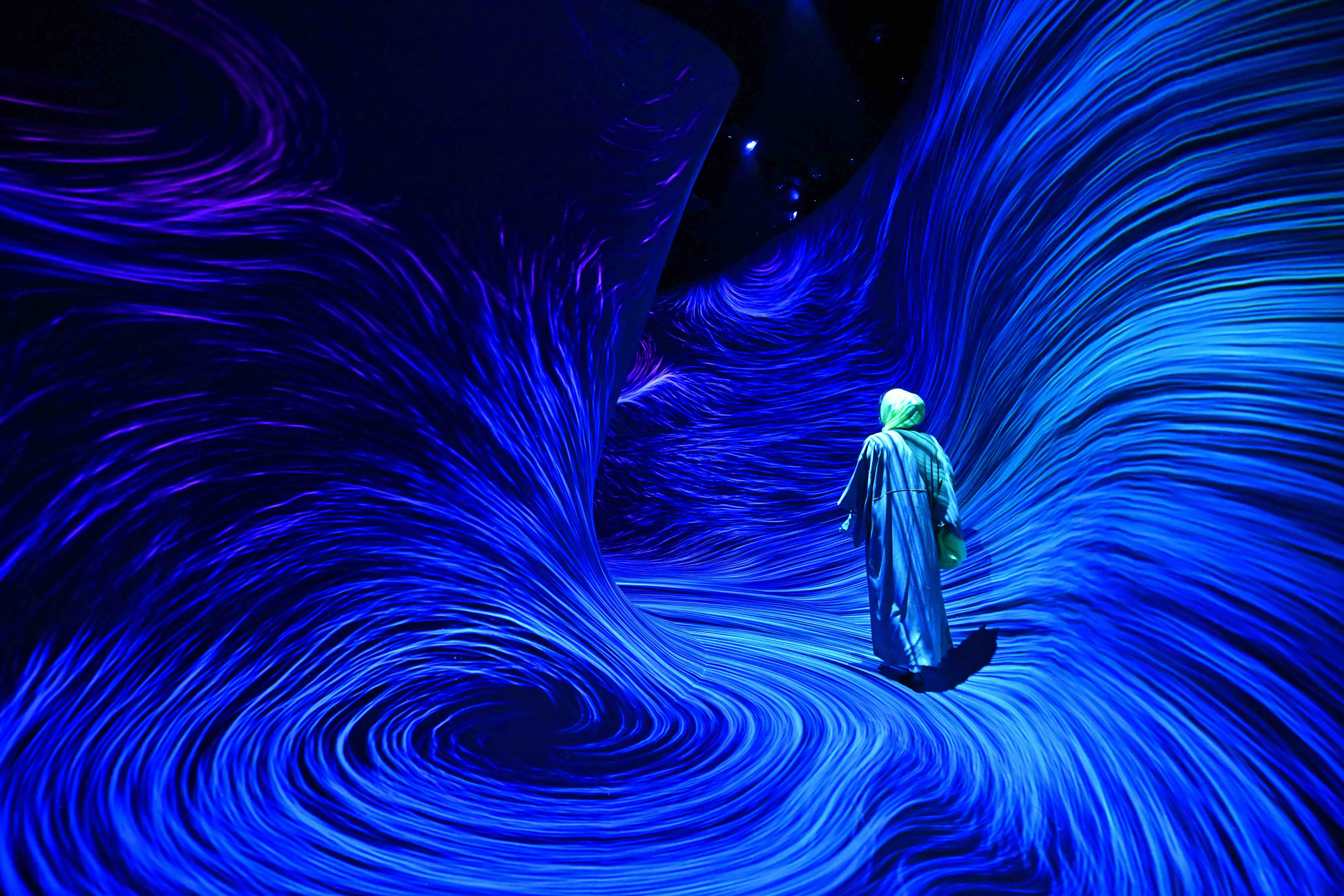 A woman visits the newly opened teamLab Phenomena, an immersive art experience museum newly opened in Abu Dhabi’s Saadiyat Cultural District. (Giuseppe Cacace /AFP via Getty Images)
