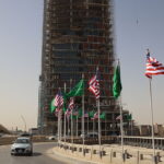 Traffic flows past Saudi and U.S. flags on a main road in Riyadh on Monday, hours before U.S. President Donald Trump is due to arrive in the kingdom. (Fayez Nureldine /AFP via Getty Images)