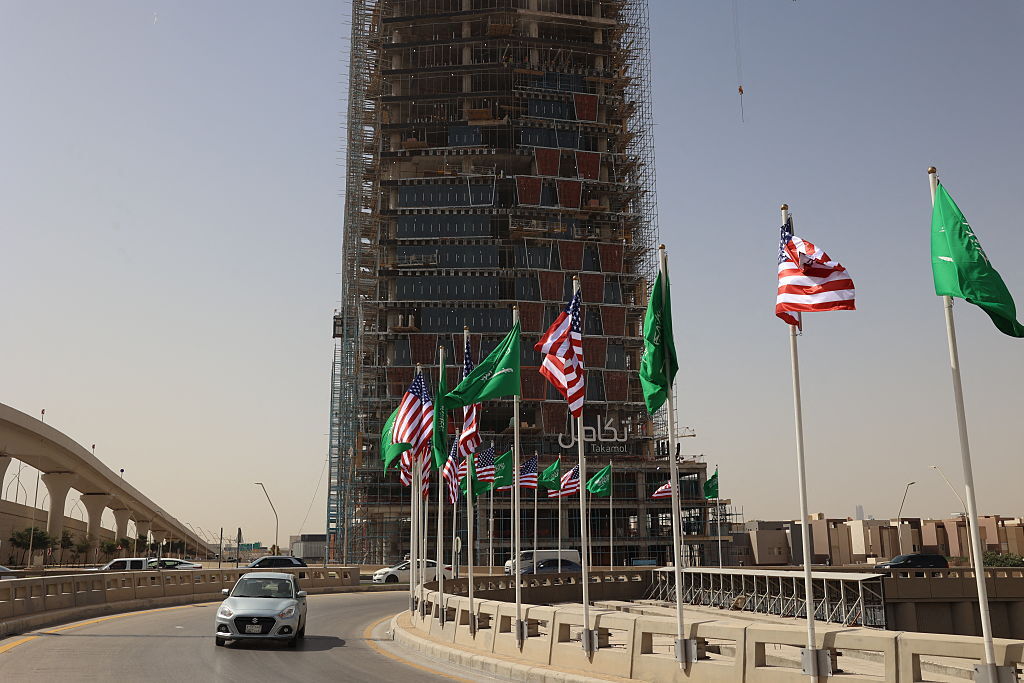 Traffic flows past Saudi and U.S. flags on a main road in Riyadh on Monday, hours before U.S. President Donald Trump is due to arrive in the kingdom. (Fayez Nureldine /AFP via Getty Images)