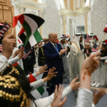 U.S. President Donald Trump and UAE President Sheikh Mohamed bin Zayed are greeted by Children waving Emirati and U.S. flags on arrival at Qasr Al-Watan palace in Abu Dhabi on Thursday evening. (Brendan Smialowski/AFP via Getty Images)