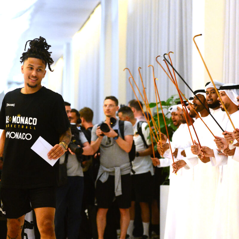 French basketballer Matthew Strazel, point guard for AS Monaco, is greeted by traditional Emirati dancers on arrival at the Hilton on Abu Dhabi’s Yas Island, where the Turkish Airlines EuroLeague Final Four will take place this weekend. (Luca Sgamellotti/Euroleague Basketball via Getty Images)