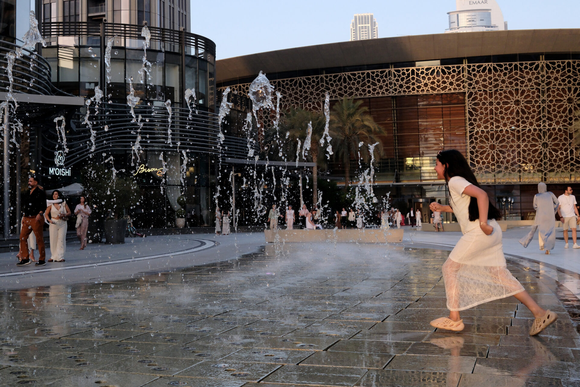 A child runs through a fountain in front of the Dubai Opera on May 24, as pre-summer temperatures soar in the UAE. (Giuseppe Cacace / AFP via Getty Images)