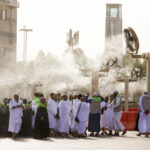 Pilgrims in Mecca shelter from the heat under giant fans blowing a cool mist, one of the measures Saudi Arabia has taken to protect pedestrians from heat as the Hajj Pilgrimage approaches. A newly opened walkway also includes heat-reducing plastic surfaces, lighting and rest areas with mobile phone charging stations. (Esra Hacioglu/Anadolu via Getty Images)