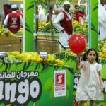 A girl walks past stalls during the Indian Mango Festival at Souq Waqif in Doha on Thursday. Gulf countries are among the biggest importers of Indian mangoes, which are in peak season from June to July. (Karim Jaafar / AFP via Getty Images)
