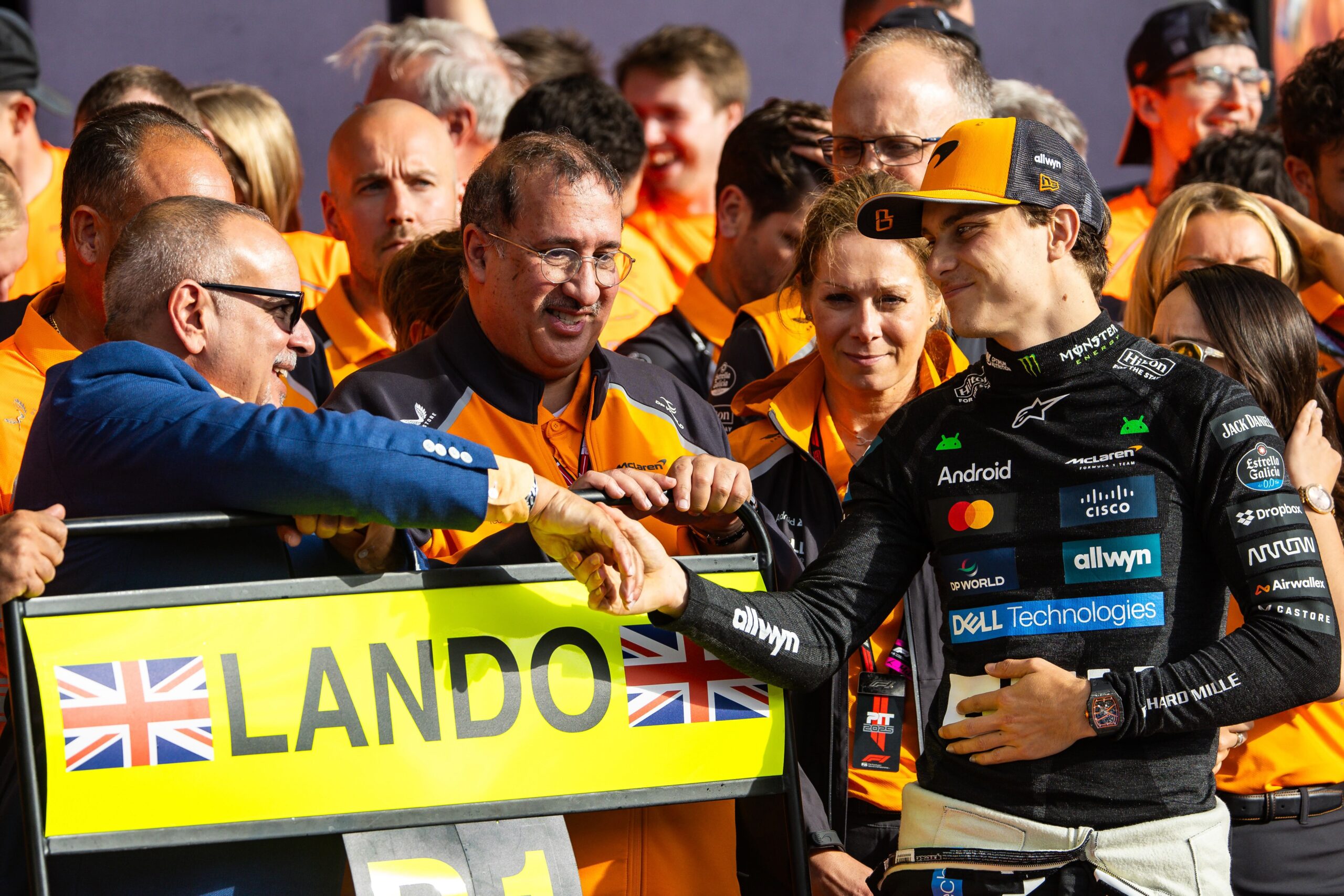 Prince Salman bin Hamad Al Khalifa, Bahrain’s Crown Prince and Prime Minister, greets Oscar Piastri of Australia and team McLaren in the pit lane during Britain’s F1 Grand Prix at Silverstone Circuit on Sunday. (Jayce Illman/Getty Images)