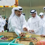 Attendees examine fresh dates at the 10th edition of the Local Dates Festival at Souq Waqif traditional market in Doha, Qatar, on Thursday. The festival includes produce from more than 100 date farms in Qatar. (Noushad Thekkayil/NurPhoto via Getty Images)